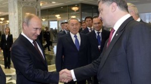 Russian President Vladimir Putin shakes hands with his Ukrainian counterpart Petro Poroshenko in Minsk