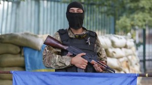 A soldier of Ukrainian self-defence battalion "Azov" stands guard at their base in Mariupol